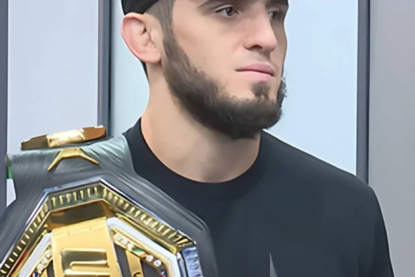 Islam Makhachev celebrates with the UFC welterweight championship belt after defeating Jack Della Maddalena at UFC 322.