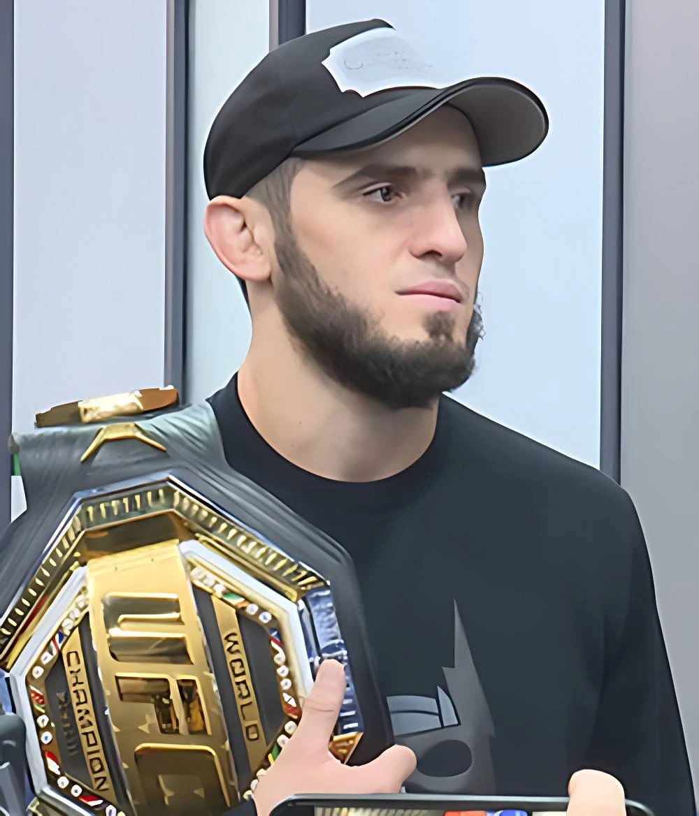 Islam Makhachev celebrates with the UFC welterweight championship belt after defeating Jack Della Maddalena at UFC 322.