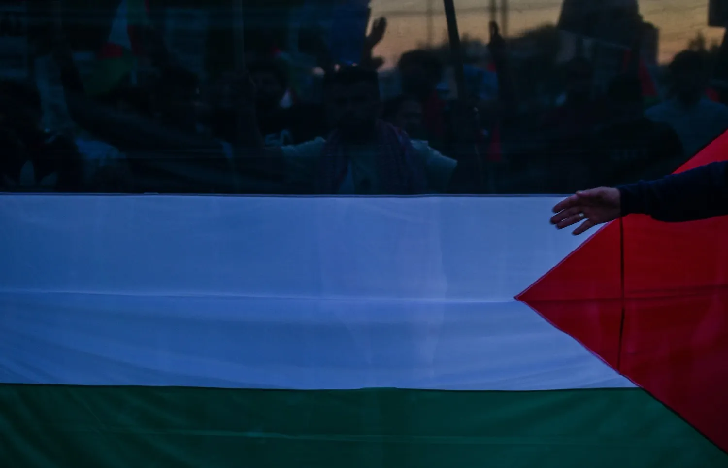 Palestinian flag during a gathering as reports emerge of a hostage’s body returned from Gaza to Israel.
