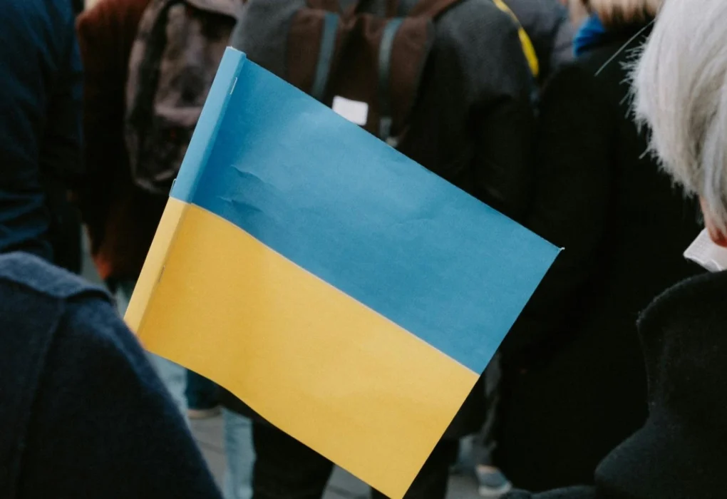 A person holding the Ukrainian flag during a public gathering in Kyiv.