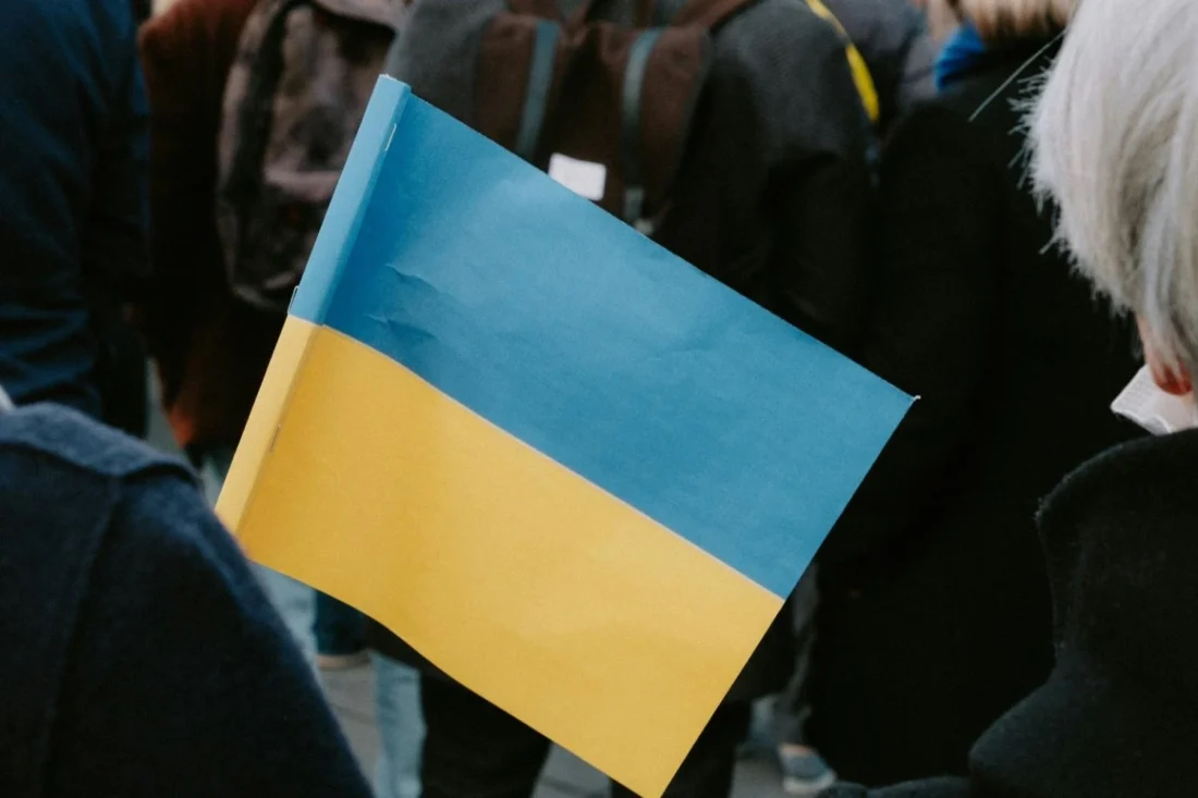 A person holding the Ukrainian flag during a public gathering in Kyiv.