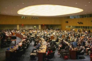 Delegates gather inside a United Nations meeting hall as the Security Council reviews and approves the Gaza stabilization plan.