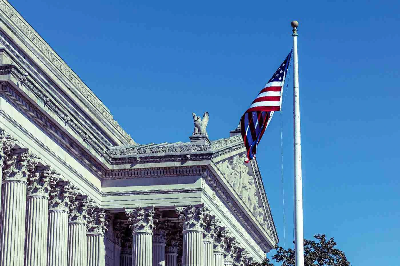 U.S. Capitol building with the American flag flying, symbolizing the end of the government shutdown.