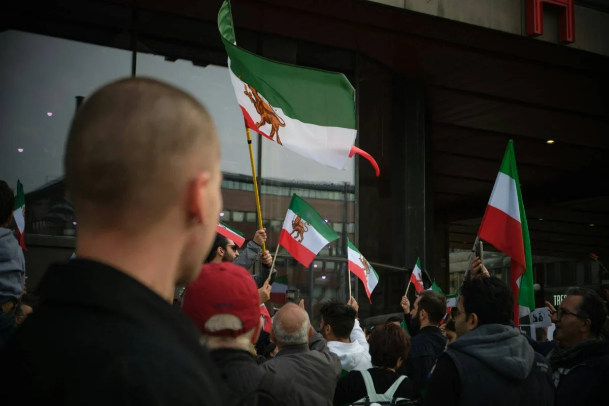 Iranian opposition flags displayed at a public gathering amid ongoing Iran protest tensions