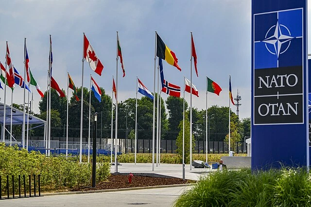 NATO headquarters with member nation flags in Brussels during alliance discussions