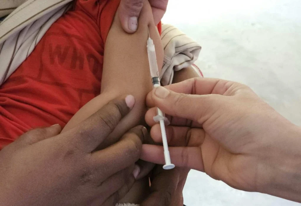 Child receiving MMR vaccination in upper arm to protect against measles