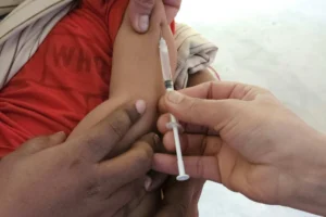 Child receiving MMR vaccination in upper arm to protect against measles