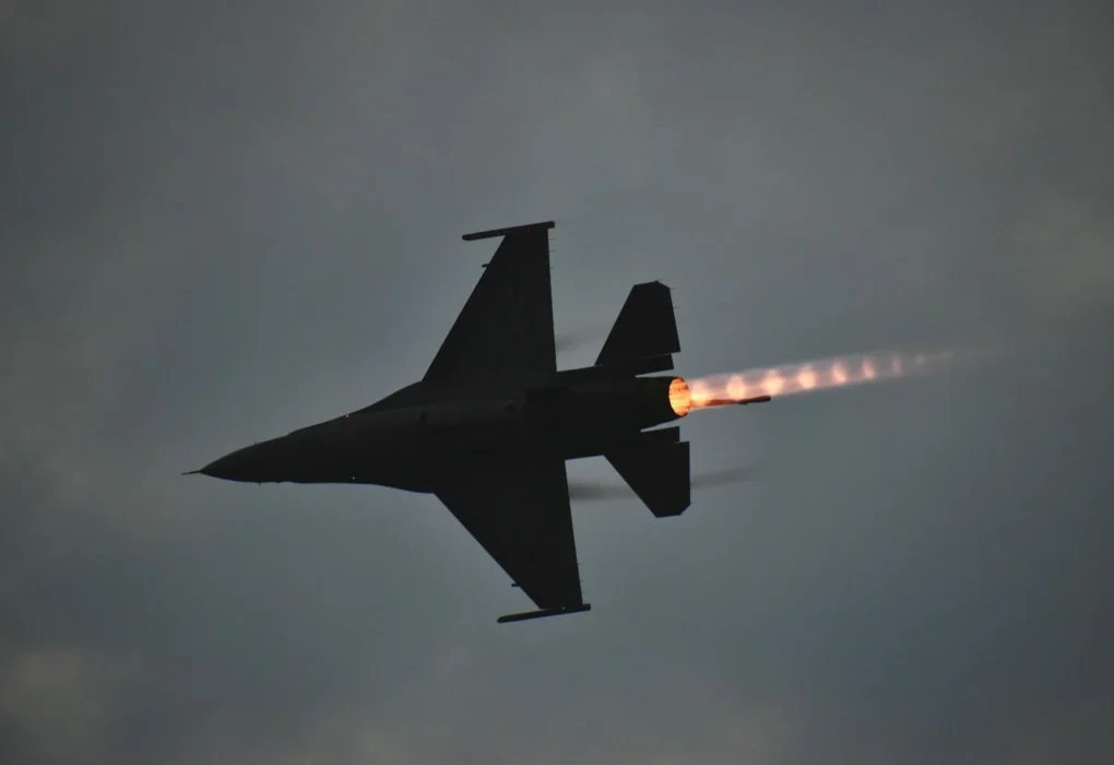 Silhouette of a fighter jet flying with afterburner flame visible against a cloudy sky, representative image for Pakistan air strikes near the Afghanistan border