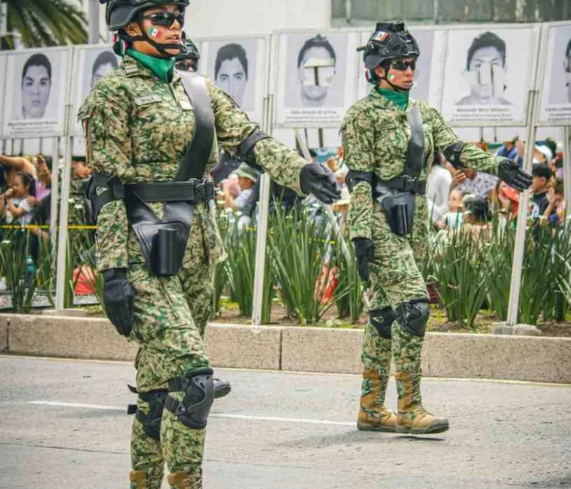 Mexican National Guard members in camouflage uniforms marching during a public security operation