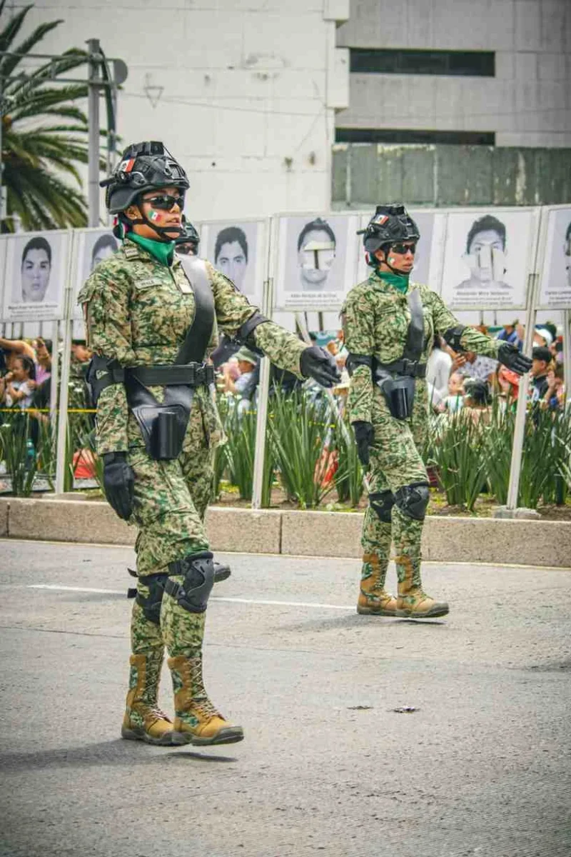 Mexican National Guard members in camouflage uniforms marching during a public security operation