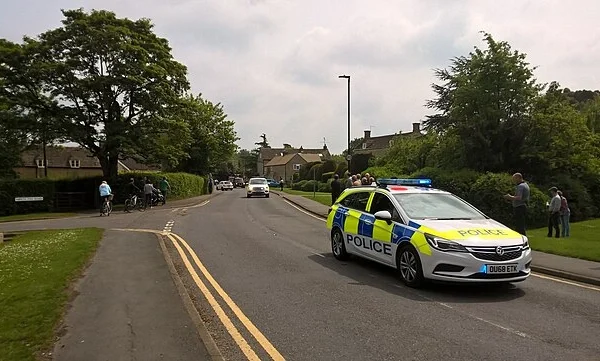 UK police car outside a station representing a sitting MP detained during an ongoing police investigation