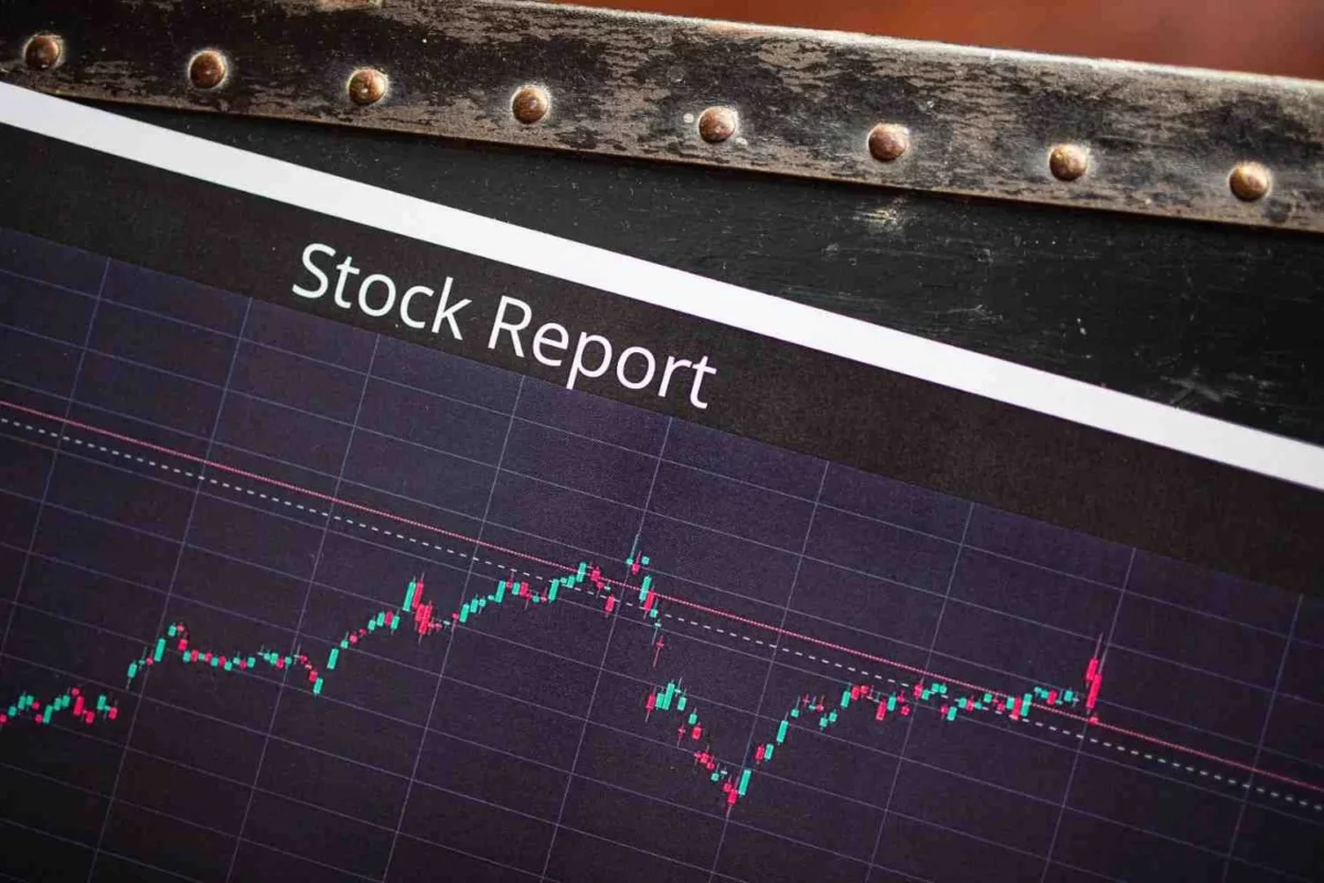Financial stock report showing red and green candlestick price chart on a market analysis screen