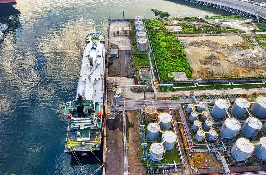 Oil storage tanks and tanker vessel at a petroleum export terminal